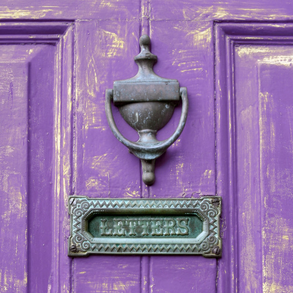 A letterbox in a purple door